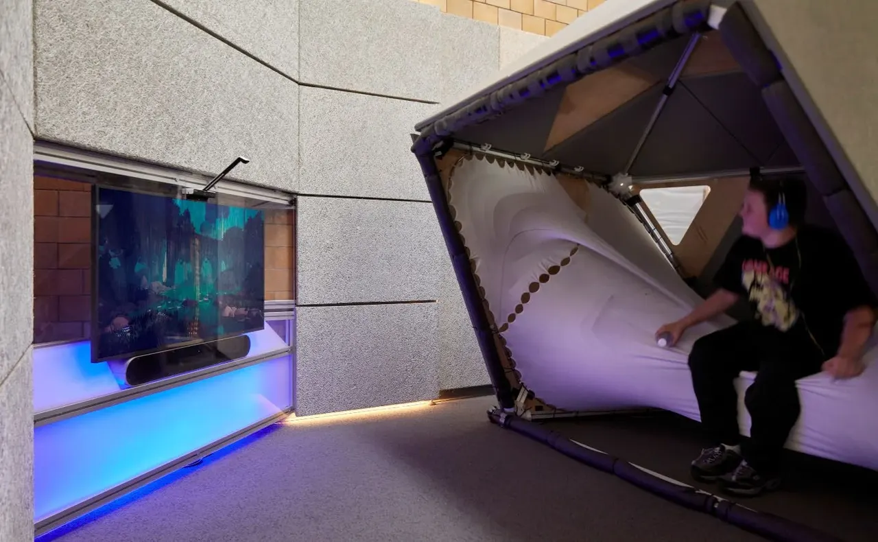 A student in the cocoon of the Lane Tech sensory hub, beside the Ouva media wall